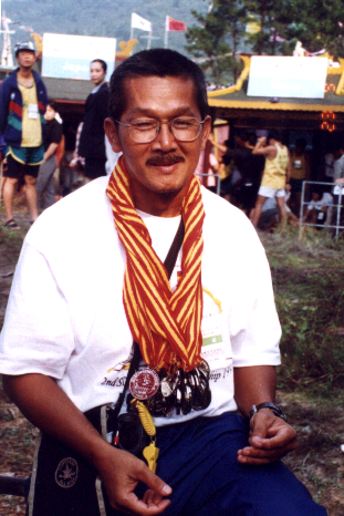 Our Coach Mr Ng Sin Teik with all our winning medals dangling at his neck! :P